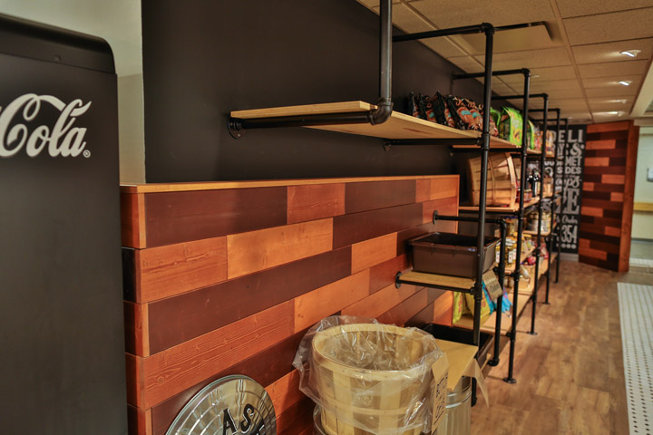 wood-panel wall pipe-rail shelves